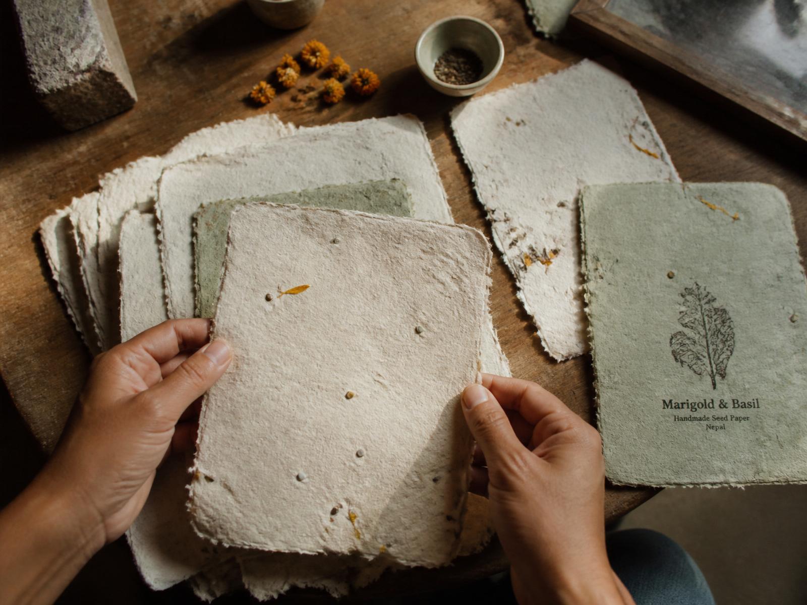 Stack of handmade seed paper with marigold and basil seeds